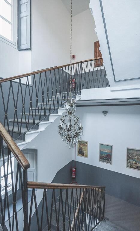 Historic staircase and chandelier inside Hotel Villa Aurora